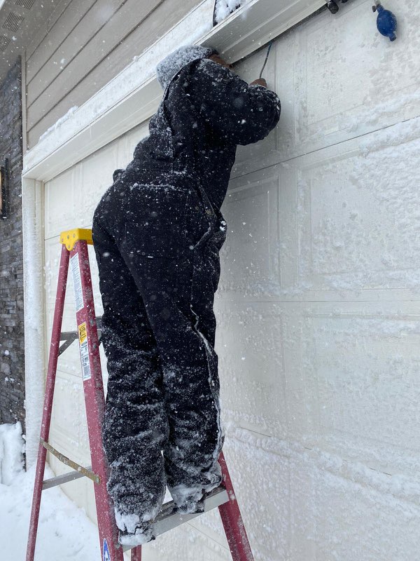 A locksmith skillfully unlocking a front door in a residential setting, emphasizing speed and efficiency. Soft, warm lighting suggests a welcoming atmosphere despite the lockout situation. The locksmith appears professional and reassuring.